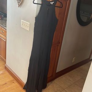 Flowy pleated black jumpsuit that looks like a dress when you walk!  Size large.